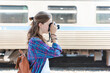 © Rawpixel.com - Traveler photographing train station scene.