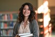 © Mykola - Latina teacher holding textbooks in a warm library atmosphere