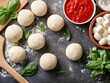 © Liliya - Pizza dough balls with fresh basil, mozzarella cheese, and tomato sauce on rustic background. Ingredients for homemade Italian pizza, top view.