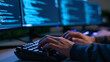 © InfinityVisuals - Coding in Progress: Close-up on hands typing on a keyboard, with multiple computer screens displaying lines of code in the background, highlighting the process of software development and programming.