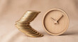 © Nazia - Curved stack of gold coins beside wooden clock for time is money and savings concept