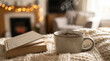 © NikProArt - Steaming cup of herbal tea and open book on cozy knitted blanket in