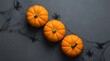 © MdLutfur - Halloween Pumpkins and Spiders on Dark Background Flat Lay Holiday Decor