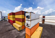 © Emilio - Stacked shipping containers and reefer units in port container yard, wide angle