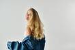 © LIGHTFIELD STUDIOS - Young woman radiates style and charm in trendy attire against a light backdrop