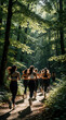 © Viktor - Group of athletic women run together on forest trail path. Fit female friends in sportswear practice jogging through green woods. Active ladies perform cardio workout outdoors for health, fitness