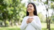 © NaesyaStudio - Happy Young Asian Girl with Hands on Chest Feeling Grateful and Thankful in Green Park