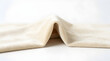 © Arman - Beige velvet fabric folded to create a soft wave with copy space