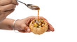 © abdul hanan - Traditional Indian panipuri golgappa street food, crispy puri shell filled with potatoes, pouring spiced tamarind water on white background