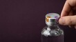 © KohXD - Realistic visualization of fraud prevention with a tamper-evident glass product bottle featuring aluminum cap