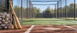 © thiwaporn - Wooden baseball bats and a basket of balls in a sunny outdoor batting cage