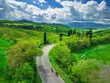 © Westend61 - Man and woman cycle on a rural road in Tuscany