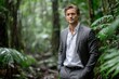 © YouraPechkin - Man in formal attire standing confidently in a lush rainforest during light rain