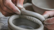 © artestdrawing - Close up of Ceramicist Hands Joining Clay Coils to Build Pottery
