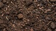 © nadimgdx - Top view of dark fertile soil texture with organic matter and small wood chips for gardening and agriculture background