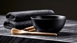 © Anindya - A minimalist setting featuring a black bowl, soft towels, and wooden brushes on a polished surface