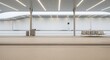 © Keo - A modern, minimalist train station platform extends into the distance. The platform is constructed of concrete and features a long, white wall on the right.