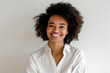 © PujiRahayu - Woman with curly hair smiles broadly at the camera.