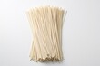 © miss irine - Dry handmade noodles lie on white background. Raw pasta strands arranged in bundle. Uncooked spaghetti egg noodles ingredient for cooking italian asian meal. Close up shot of wheat starch food for
