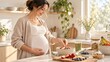 © Kristina - Pregnant woman preparing a fruit bowl in a home kitchen. Healthy pregnancy nutrition and prenatal wellness. Expectant motherhood and balanced diet. Fresh food for family health.
