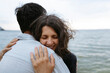 © Westend61 - A happy couple hugs each other at the beach during summer vacation