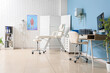© Pixel-Shot - Physical therapy and massage clinic, medical office interior with treatment table, anatomical skeleton model and desk for patient consultation and records