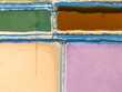 © Amazing Aerial - Aerial view of colorful salt evaporation ponds at Bedwell Bayfront Park with vibrant green, orange, yellow, and pink water separated by narrow dikes, Menlo Park, California, United States.