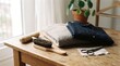 © Afrina - Garment care tools and folded clothing rest on a wooden table