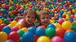 © Dao - Playful Children in Ball Pit. Joyful kids enjoying colorful ball pit at indoor playground.