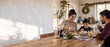 © ON - Studio - Multi-ethnic family of three enjoying a hearty breakfast together at a rustic wooden table, surrounded by remnants of Christmas decorations