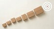 © matkhairul - Row of brown cardboard mailing boxes in graduated sizes arranged diagonally upward towards a white bullseye icon with a red center on a light cream minimalist surface.