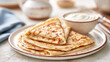 © CreativeArt - Stacked blini or crepes with sour cream, a classic russian dish, warm breakfast or dessert