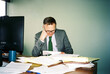 © Cara Dolan/Stocksy - Man working in office with messy desk on film