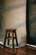 © Vera Lair/Stocksy - Wooden Stool Next to Backdrop in a Studio Setting