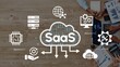 © InfiniteFlow - Cloud Computing Concept Featuring SaaS Application with Icons and Team Collaboration on Digital Devices in a Modern Workspace. Entropy.