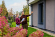 © ronstik - Couple viewing modern new house with landscaped garden. Property inspection before buying. Real estate market