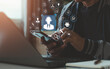 © MUNTHITA - Customer service and technical support technology concept. User's hand using a smartphone with a digital icon, AI assistance, chat, email, call center, global service for online business, IT solution.