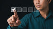 © Its_Pictography - Digital Selection: A focused man touches a virtual checkmark on a digital interface screen, symbolizing positive evaluation, quality assurance, and decision making.