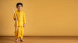 © MDMONIR - A young boy dressed in traditional yellow indian clothing stands against a warm golden ad social media download thambnail poster web template event festival 2026 2027 2028