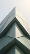 © nordantin - Material-focused architectural scene of a folded faceted facade creating deep triangular shadows, with its physical process or state transition clearly visible for business, engineering and modern