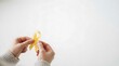 © GRAPHIC - Hands holding a yellow awareness ribbon for medical support and