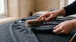 © starush - Brushing a charcoal cashmere cardigan with care