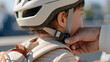 © AnastasiiaRozhmanova - Macro close up of a certified bicycle helmet buckle being fastened under a young child's chin by careful adult fingers, safety equipment, proper fit check, toddler cycling