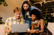 © Adrian Rodd/Stocksy - Digital team working together on a laptop to develop innovative ideas.