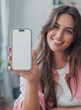 © Daniel - Young woman holds a smartphone mockup with a blank white screen toward the camera. Vertical mobile device offers copy space for app, website, advertising, interface, and communication design.
