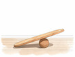 © Toufiqul - Wooden balance board resting on a spherical ball on a wooden floor, representing a concept of balance, stability, and physical equilibrium