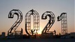 © joeycheung - Workers assemble giant 2021 numerals at sunset, symbolizing new year's arrival.