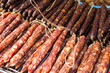© leungchopan - Pile of dried cured pork sausage on display at local market