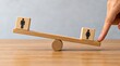 © Naveed - Workplace gender equality concept shown with balanced employee figures on a wooden scale