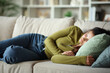 © Antonioguillem - Young woman is sleeping lying on a couch at home